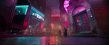 Movie still from “Cats” (2019), directed by Tom Hooper – A couple of people standing on a wet street at night; Extreme Wide shot, Low angle