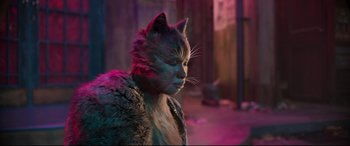 Movie still from “Cats” (2019), directed by Tom Hooper – A woman in a cat costume looking to the side; Close Up shot, Over the shoulder angle