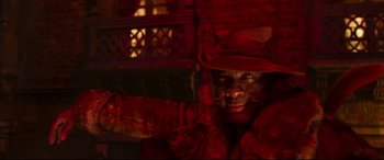 Movie still from “Cats” (2019), directed by Tom Hooper – A man in a red coat and a red hat; Close Up shot, Over the shoulder angle