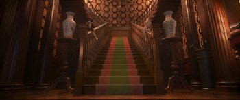 Movie still from “Cats” (2019), directed by Tom Hooper – The stairs are decorated with a green and red striped carpet; Extreme Wide shot, Low angle
