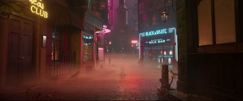 Movie still from “Cats” (2019), directed by Tom Hooper – A street scene with a cat on the sidewalk; Extreme Wide shot, High angle