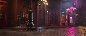 Movie still from “Cats” (2019), directed by Tom Hooper – A lamp post in front of a building at night; Wide shot, Low angle