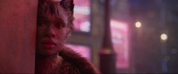 Movie still from “Cats” (2019), directed by Tom Hooper – A woman with a cat mask on her face; Close Up shot, Over the shoulder angle
