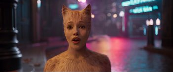 Movie still from “Cats” (2019), directed by Tom Hooper – A woman in a cat costume standing on a street; Close Up shot, Over the shoulder angle