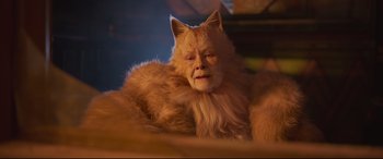 Movie still from “Cats” (2019), directed by Tom Hooper – An old man with a cat's face sitting on top of a bed; Close Up shot, High angle