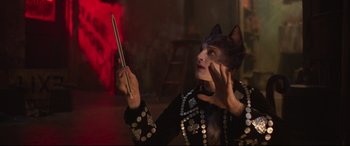 Movie still from “Cats” (2019), directed by Tom Hooper – A woman in a cat costume looking at a cell phone; Close Up shot, Over the shoulder angle