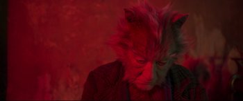 Movie still from “Cats” (2019), directed by Tom Hooper – A man with a red mask on his face; Close Up shot, High angle