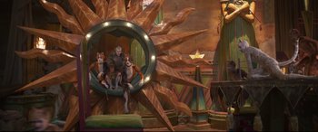 Movie still from “Cats” (2019), directed by Tom Hooper – A group of dogs sitting on top of a wheel in a room; Wide shot, High angle