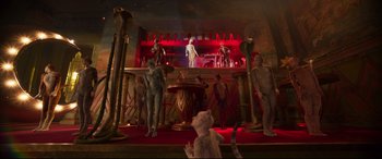 Movie still from “Cats” (2019), directed by Tom Hooper – A group of people standing around a bar; Wide shot, High angle