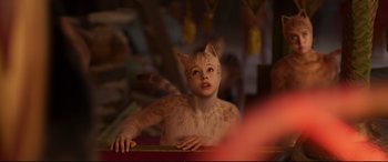 Movie still from “Cats” (2019), directed by Tom Hooper – A woman in a cat costume looking up at the ceiling; Close Up shot, Over the shoulder angle