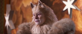 Movie still from “Cats” (2019), directed by Tom Hooper – A woman in a cat costume is looking at the camera; Close Up shot, High angle