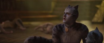 Movie still from “Cats” (2019), directed by Tom Hooper – A man in a cat costume looking up at the sky; Close Up shot, Low angle
