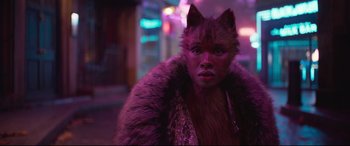 Movie still from “Cats” (2019), directed by Tom Hooper – A woman with a cat mask and a purple fur coat; Close Up shot, Over the shoulder angle