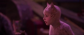 Movie still from “Cats” (2019), directed by Tom Hooper – A woman in a cat costume looking to the side; Close Up shot, Over the shoulder angle