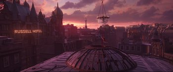 Movie still from “Cats” (2019), directed by Tom Hooper – A crane is lifting a basket on top of a building; Extreme Wide shot, Low angle