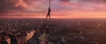 Movie still from “Cats” (2019), directed by Tom Hooper – A monkey hanging from a rope over a large city; Extreme Wide shot, High angle