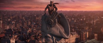 Movie still from “Cats” (2019), directed by Tom Hooper – An image of a statue of a cat on top of a building; Extreme Wide shot, High angle