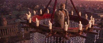 Movie still from “Cats” (2019), directed by Tom Hooper – A woman standing in front of a chandelier with candles; Wide shot, High angle