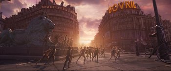 Movie still from “Cats” (2019), directed by Tom Hooper – A group of people standing on top of a street; Wide shot, High angle