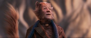 Movie still from “Cats” (2019), directed by Tom Hooper – A man with a cat's face and a sweater around his neck; Close Up shot, Low angle
