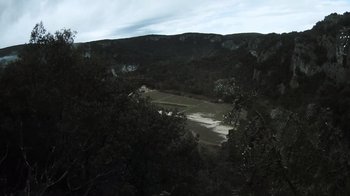 Movie still from “Cave of Forgotten Dreams” (2010), directed by Werner Herzog – A view of a valley from a hill side; Extreme Wide shot, High angle