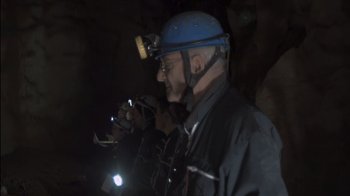 Movie still from “Cave of Forgotten Dreams” (2010), directed by Werner Herzog – A man with a helmet and a light on his head; Medium shot, Low angle