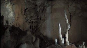 Movie still from “Cave of Forgotten Dreams” (2010), directed by Werner Herzog – A cave filled with lots of rocks and ice formations; Wide shot, Low angle