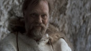 Movie still from “Cave of Forgotten Dreams” (2010), directed by Werner Herzog – An old man with a beard and a fur coat; Close Up shot, Low angle