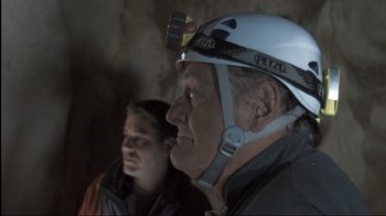 Movie still from “Cave of Forgotten Dreams” (2010), directed by Werner Herzog – A man wearing a hard hat and a woman wearing a white helmet; Close Up shot, Over the shoulder angle