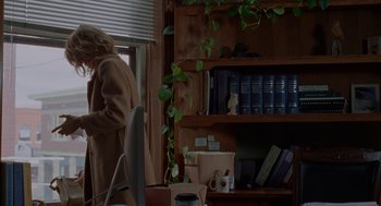 Movie still from “Certain Women” (2016), directed by Kelly Reichardt – A woman standing in front of a book shelf; Wide shot, Over the shoulder angle