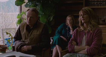 Movie still from “Certain Women” (2016), directed by Kelly Reichardt – A group of people sitting in a room; Medium shot, Over the shoulder angle