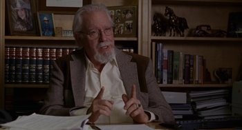 Movie still from “Certain Women” (2016), directed by Kelly Reichardt – An older man sitting at a table in a room; Close Up shot, High angle