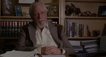 Movie still from “Certain Women” (2016), directed by Kelly Reichardt – An older man sitting at a table in a room; Close Up shot, High angle