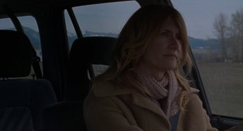 Movie still from “Certain Women” (2016), directed by Kelly Reichardt – A woman sitting in the back seat of a car; Close Up shot, Over the shoulder angle