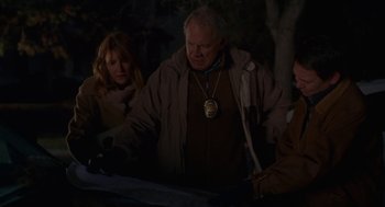 Movie still from “Certain Women” (2016), directed by Kelly Reichardt – A group of people standing next to each other in the dark; Medium shot, High angle