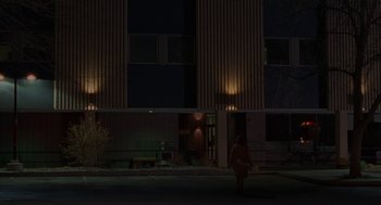 Movie still from “Certain Women” (2016), directed by Kelly Reichardt – A woman walking down a street at night; Extreme Wide shot, Low angle