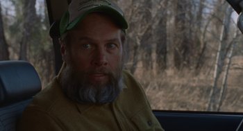 Movie still from “Certain Women” (2016), directed by Kelly Reichardt – A man with a beard wearing a hat; Close Up shot, Over the shoulder angle