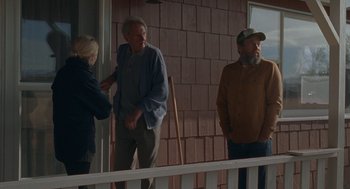 Movie still from “Certain Women” (2016), directed by Kelly Reichardt – A group of people standing on the porch of a house; Medium shot, Over the shoulder angle