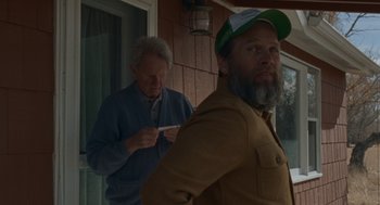 Movie still from “Certain Women” (2016), directed by Kelly Reichardt – A man with a beard is standing next to another man with a beard; Medium shot, Over the shoulder angle