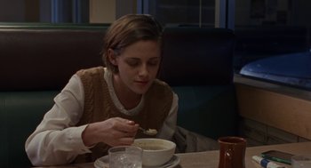 Movie still from “Certain Women” (2016), directed by Kelly Reichardt – A woman sitting in front of a bowl of soup; Medium shot, Over the shoulder angle