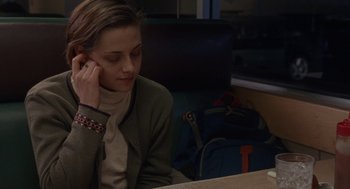 Movie still from “Certain Women” (2016), directed by Kelly Reichardt – A woman sitting in front of a computer desk; Medium shot, Over the shoulder angle
