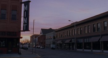 Movie still from “Certain Women” (2016), directed by Kelly Reichardt – A view of a city street at dusk; Extreme Wide shot, Low angle