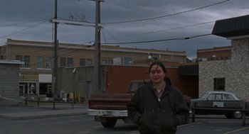 Movie still from “Certain Women” (2016), directed by Kelly Reichardt – A woman standing in the middle of a street; Wide shot, Low angle