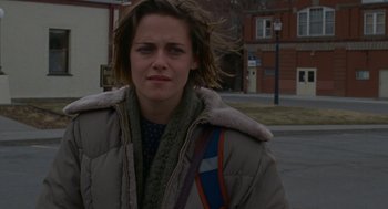 Movie still from “Certain Women” (2016), directed by Kelly Reichardt – A person wearing a jacket on the street; Close Up shot, Over the shoulder angle
