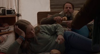 Movie still from “Certain Women” (2016), directed by Kelly Reichardt – A man and a woman sitting on the ground; Medium shot, High angle