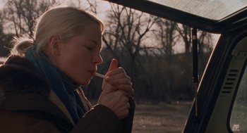 Movie still from “Certain Women” (2016), directed by Kelly Reichardt – A woman holding a cigarette in her mouth; Close Up shot, Low angle