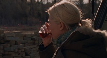 Movie still from “Certain Women” (2016), directed by Kelly Reichardt – A woman drinking a glass of wine outside; Close Up shot, Over the shoulder angle