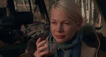 Movie still from “Certain Women” (2016), directed by Kelly Reichardt – A person holding a cup of coffee; Close Up shot, Over the shoulder angle