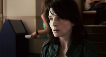 Movie still from “Certified Copy” (2010), directed by Abbas Kiarostami – A person wearing a green shirt; Close Up shot, Over the shoulder angle