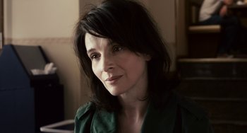 Movie still from “Certified Copy” (2010), directed by Abbas Kiarostami – A person wearing a green shirt; Close Up shot, High angle